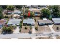 A birds eye view shows the home with a well-manicured lawn and an inviting neighborhood with a nearby pool at 5018 Sherwood Dr, New Port Richey, FL 34652
