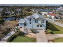 Charming waterfront home with metal roof, manicured lawn, and private canal access at 5040 Waterside Dr, Port Richey, FL 34668