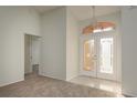 Bright foyer features tile flooring, a chandelier, and a decorative glass double door entrance at 5931 Precious View Ct, New Port Richey, FL 34655