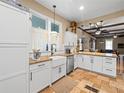 Lovely kitchen features a farmhouse sink, stainless steel appliances, and granite countertops at 606 Howell Ave, Brooksville, FL 34601