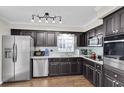 Modern kitchen features stainless steel appliances, granite counters, and dark cabinetry at 6219 Wilds Dr # 11A, New Port Richey, FL 34653