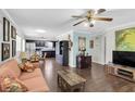Inviting living room with hardwood floors, comfortable seating, and a ceiling fan at 6219 Wilds Dr # 11A, New Port Richey, FL 34653