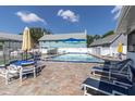 Community pool with lounge chairs and a well-kept patio area at 6219 Wilds Dr # 11A, New Port Richey, FL 34653