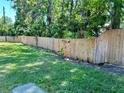 Spacious backyard with a sturdy wooden fence providing privacy at 6338 Spring Flower Dr # 15, New Port Richey, FL 34653