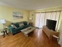 Comfortable living room with hardwood floors and a serene beach-themed artwork at 6338 Spring Flower Dr # 15, New Port Richey, FL 34653