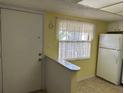 Kitchen with white cabinets, stainless steel appliances, and bright natural light at 840 Virginia St # 202, Dunedin, FL 34698