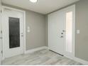 Bright entryway featuring a textured glass door, modern tile flooring, and neutral paint at 8522 Inwood Dr, Hudson, FL 34667
