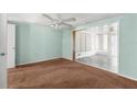 Inviting living room with a ceiling fan and carpet flooring at 9015 Mark Twain Ln, Port Richey, FL 34668