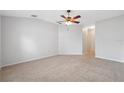 Spacious bedroom featuring neutral carpet, ceiling fan, and bright natural light at 9048 Southern Charm Cir, Brooksville, FL 34613