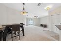 Spacious dining room area with modern lighting fixtures and seamless flow to the living area at 9048 Southern Charm Cir, Brooksville, FL 34613