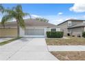 Charming single Gathering home with a well maintained lawn and an attached two car garage at 9048 Southern Charm Cir, Brooksville, FL 34613