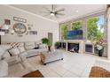 Inviting living room features tile floors, large windows, and a cozy fireplace at 9245 Grand Cypress Dr, Spring Hill, FL 34613