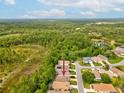 Aerial view of the home's location surrounded by lush greenery and nearby homes in the neighborhood at 10187 Holly Berry Dr, Weeki Wachee, FL 34613