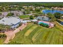 Aerial view of the community clubhouse, pool, and tennis courts, showcasing the recreational amenities at 10187 Holly Berry Dr, Weeki Wachee, FL 34613