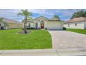 Beautiful single-Gathering home with a lush front lawn and brick-paved driveway at 1032 Walnut Hill Ct, Spring Hill, FL 34609
