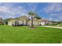 Well-maintained home with a green lawn, mature palm tree, and charming curb appeal at 1032 Walnut Hill Ct, Spring Hill, FL 34609