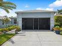 Spacious two-car garage with screen doors and concrete driveway offering ample parking space at 11342 Hollander Ave, Hudson, FL 34667