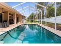 Enjoy a refreshing swim in this beautiful screened-in pool, perfect for relaxing and entertaining outdoors at 11443 Marsh Creek Ct, New Port Richey, FL 34654
