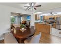 Open dining area with hardwood floors and seamless flow to the kitchen and living spaces at 11512 Yellow Birch Ct, New Port Richey, FL 34654