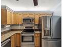 This renovated kitchen features stainless steel appliances and light wood cabinets at 11512 Yellow Birch Ct, New Port Richey, FL 34654