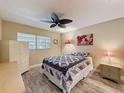 Cozy bedroom featuring wood-look floors and a ceiling fan for added comfort at 11601 Bayonet Ln # 163A2, New Port Richey, FL 34654
