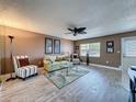 Inviting living room featuring stylish furnishings, ceiling fan, and wood-look flooring at 11601 Bayonet Ln # 163A2, New Port Richey, FL 34654