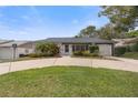 Exterior view of the home showcasing the landscaping and the front entrance at 12407 Gunstock Ln, Hudson, FL 34667
