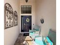 Inviting front entrance with decorative wall art, stylish seating, and a welcoming door at 13850 Royston Bnd, Hudson, FL 34669