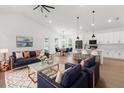 Open concept living with hardwood floors, living room area, dining space, and modern kitchen with island at 14042 Amero Ln, Spring Hill, FL 34609