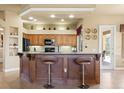 Charming kitchen featuring granite countertops, tile backsplash, a breakfast bar, and wood cabinetry at 14163 Andrew Scott Rd, Spring Hill, FL 34609