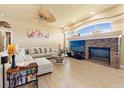 Bright living room with a ceiling fan, tile flooring, and a brick fireplace at 14163 Andrew Scott Rd, Spring Hill, FL 34609