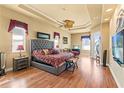 Spacious main bedroom suite featuring hardwood floors, a fan, and private seating at 14163 Andrew Scott Rd, Spring Hill, FL 34609