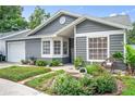 Beautiful home with manicured garden beds, a lovely front entrance, and lush lawn at 1486 Loman Ct, Palm Harbor, FL 34683