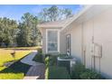 Exterior home view with a well-kept lawn, a brick sidewalk, an AC unit and nice landscaping at 15038 Sterling Run, Brooksville, FL 34609