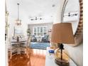 Open concept living and dining area with hardwood floors, nice furniture and decorative lighting at 15038 Sterling Run, Brooksville, FL 34609