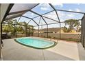 A large, screened-in pool area with a well-maintained pool and surrounding patio at 18710 Dobson Dr, Hudson, FL 34667