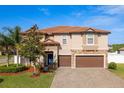 Two-story home boasts a tile roof, stone accents, and a beautifully landscaped yard at 19082 Umberland Pl, Land O Lakes, FL 34638