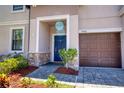 Inviting front entrance with a stylish blue door, stone accents, and a well-maintained walkway at 19082 Umberland Pl, Land O Lakes, FL 34638