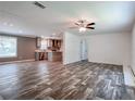Open-concept living room with hardwood floors, neutral walls, and ample natural light at 20064 Manecke Rd, Brooksville, FL 34601