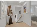 Hallway showcasing white walls, artistic décor, and tiled floors leading to a dining area at 2026 Golfview Dr # 2026, Tarpon Springs, FL 34689