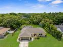 Ariel view of home showing fenced yard, mature landscaping, and detached workshop at 2122 Meadow Lark Rd, Spring Hill, FL 34608