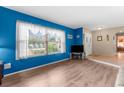 Bright living room featuring wood-look flooring and a large window at 2122 Meadow Lark Rd, Spring Hill, FL 34608