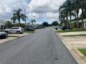 Neighborhood street featuring sidewalks and mature palm trees at 2850 Westmoreland Ct, New Port Richey, FL 34655