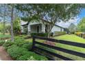 Inviting home exterior with lush landscaping, manicured hedges, and a fenced perimeter at 3056 Abrams Trl, Odessa, FL 33556