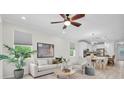 Bright living room featuring modern decor, light wood floors, and an open floor plan at 3056 Abrams Trl, Odessa, FL 33556