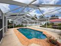 The cozy pool with a screen enclosure provides a relaxing outdoor experience with privacy and comfort at 31726 Sylvian Ln, Dade City, FL 33525