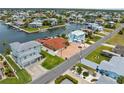 Aerial view showcasing waterfront property, brick driveway, lush lawn and neighborhood at 3361 Gulfview Dr, Hernando Beach, FL 34607