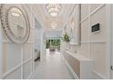 Bright entryway with stylish lighting, modern decor, and access to the living areas at 3511 Malta Ave, Wesley Chapel, FL 33543