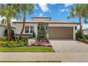 Beautiful single-Gathering home with lush landscaping, brick driveway, and two-car garage at 3511 Malta Ave, Wesley Chapel, FL 33543