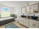 Luxurious bathroom with dual vessel sinks, a soaking tub, and modern fixtures at 4128 Camelia Dr, Hernando Beach, FL 34607